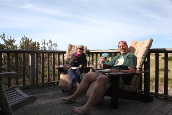 The author and his wife enjoy a glass of wine on the sunny deck of the dune shack on the first evening.