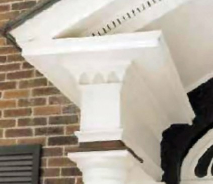 Figure 8. Flat surfaces are especially susceptible to water damage. To fend off problems, the column cap here is completely capped with metal flashing, and the eaves return is also extensively flashed.