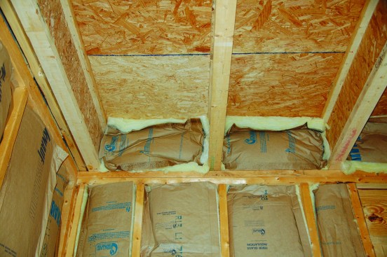 Band joists are among the leakiest areas in a house. Insulation stuffed between joists is not an air-seal.