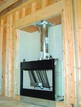 One way to do it is with a "box-in," which results in a sealed chamber for the fireplace insert. The boxed-in chamber will be hidden once drywall is hung on the walls.