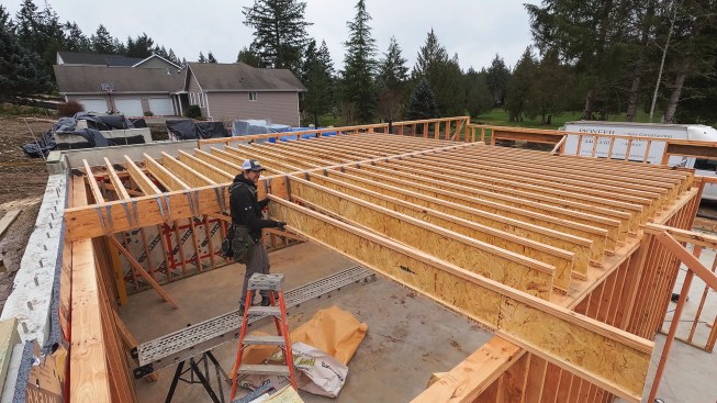 The crew then hung 11 7/8-inch I-joists from the beam 12 inches on-center. Note that the entire subslab system is dropped below the main-level floor system to accommodate the thickness of the garage slab.