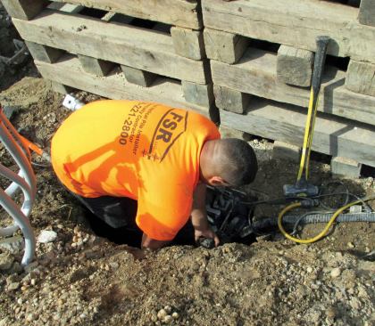Most of the new helical piles were placed on the inside of the footing to counterbalance the existing piles. After sinking each pile, the drive head gets cut off with a portable band saw and the pile stem is bolted to a bracket.