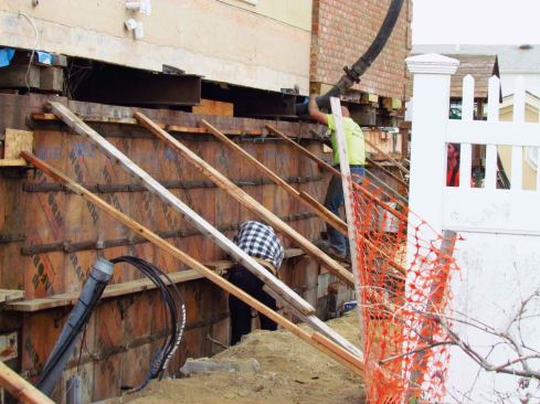 We used a pump truck with a 100-foot boom to get the concrete to the back of the house, and the pressure on this hose was tremendous. It was harrowing for the crew to try to bend that hose into the form with less than a foot of access between the house and the top of the forms. If I had to do it all over again, I would have paid for another jump on the jacks to give ourselves more room.
