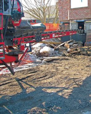 A conveyor truck is helping to speed the work of getting sub-slab fill beneath the house, and to spread it around the site.