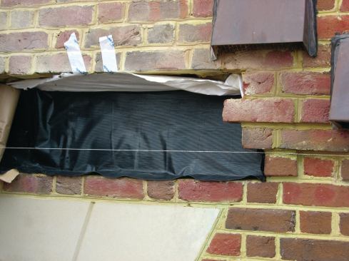 The other critical detail on any through-wall flashing is the end dam, which is simply a fold at each end of the flashing that brings the material up into a vertical head joint. This detail allows the flashing to function more like a collection channel, or spout, than a flat membrane. Creating an end dam is also more reliable than trying to seal overlapping pieces of flashing: Whenever we need a mid-span joint in flashing for a long run, we create end dams, turning the ends of each piece up into a head joint.