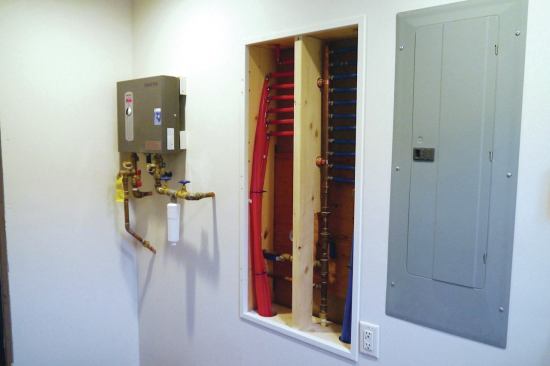 A pair of 2x4 cleats attached to the wall made it easier to install the water heater using threaded fittings.