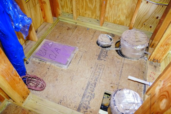 Instead, supply and return duct runs are capped with plastic wrap and tape in the mechanical room.