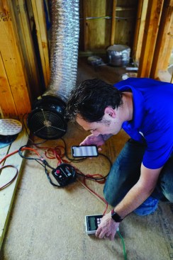 With the flow restrictor in place, Harris recalibrates thepressure and flow gauge, and uses his smartphone to calculate the equivalent leakage rate.