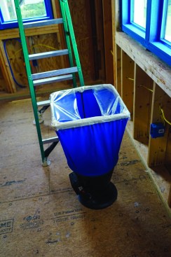 Because he’s testing the system with no drywall installed,Harris masks off the parts of the flow hood that would ordinarily be blocked by the drywall.