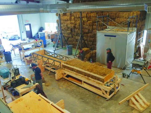 The panels are moved onto another work table for installation of Gutex insulation and Intello vapor barrier.