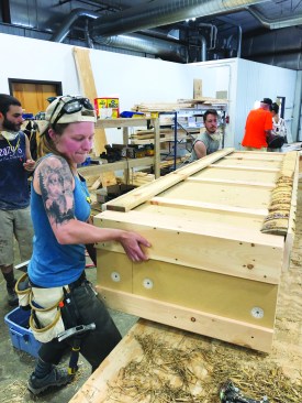 Panel assembly takes place on tables at a convenient working height.