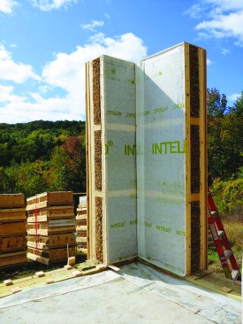 Panels are set on site using telehandler forklifts. Above, a corner has been assembled from two panels on site.