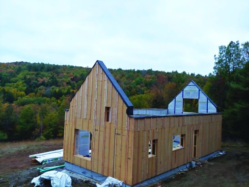 The completed walls of the house sit ready for roof trusses