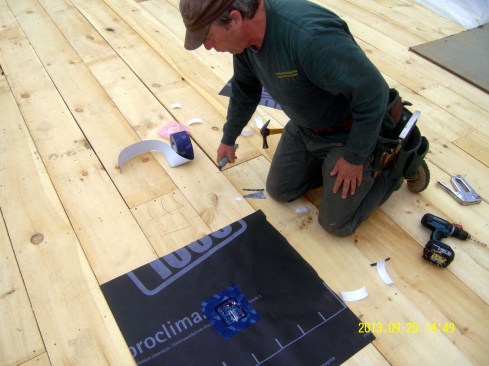Chris Miksic installs a PowerWise moisture sensor probe in the upper layers of an unvented flat roof for a Passive House building in rural Vermont.