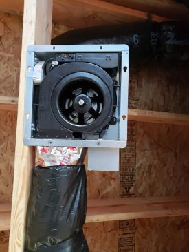 A look inside the housing of the Panasonic WhisperValue fan shows the controls that allow the installer to select an exhaust airflow of 50, 80, or 100 cfm (above). The relative humidity set point of the room can also be dialed in for the condensation sensor.