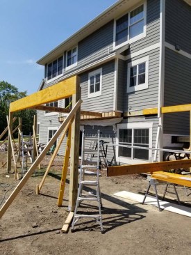 The deck’s 6x6 PT support posts bear on helical piles rather than oversized concrete footings. On this project, the Techno-Post subcontractor installed P2 shafts with a 16-inch-diameter helix, which have a maximum depth of 12 feet and compression rating of 6,500 pounds.