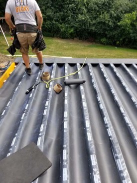 Around the perimeter of the deck, another membrane layer directs water away from the top of the LVL framing and back into the troughs.