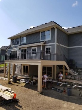 The nearly completed deck features an expansive dry area underneath, ready for paver patio installation.