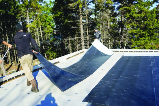 To simplify the work on the valley portion of the roof, they split one section of EPDM in half.