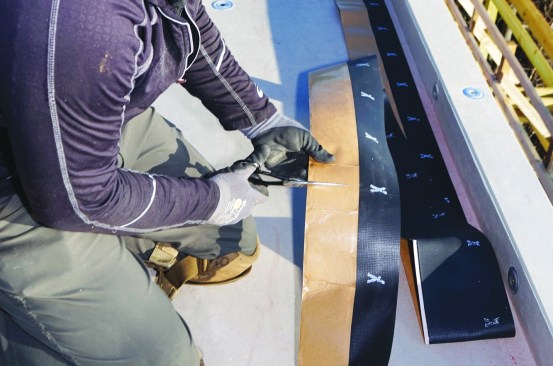 The reinforced perimeter strip (RPS) is cut to length.