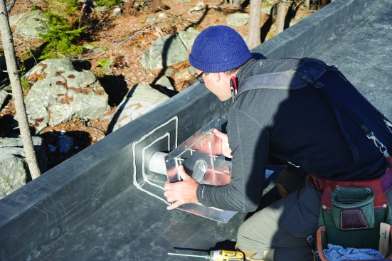 Next, he sets the scupper in place.
