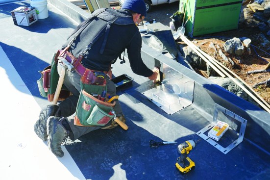 Then he primes the EPDM to prepare it for flashing and counterflashing with uncured EPDM flashing.