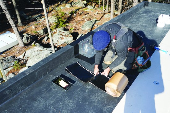 The author cuts short sections of EPDM flashing.