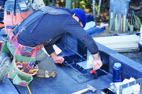 The flashing is rolled with a small roller for better adhesion.
