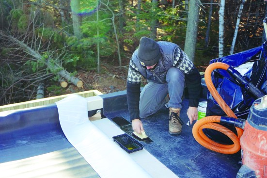 Crew member Finn Bradenday primed the EPDM at the lap joint.