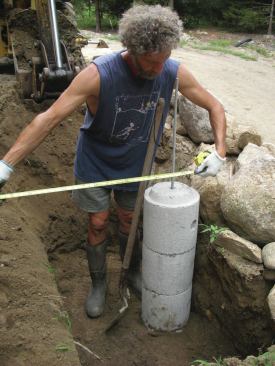 A plumb bob or laser can be used to position the center of the base, but there’s also some adjustability as the sections are being stacked. Here, the author checks the position of the connecting rod against his original layout.