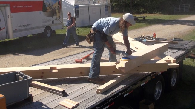 Carpenter Toby Swanson gives the collar tie a quick final sanding before assembly.
