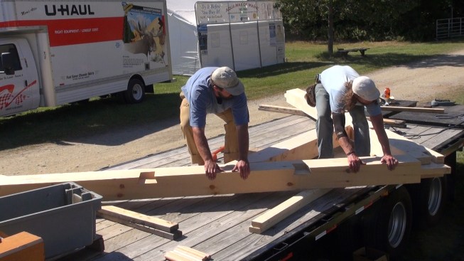 Working on the bed of the company's flatbed truck, Toby Swanson and Chris Krouse assemble the gable end rafter pair and collar tie. The truck makes a handy flat surface for assembling bents on a rough jobsite, notes company owner Richard Krouse.