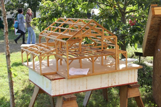 R. A. Krouse's scale model on display at the fair, sitting on a table made of sawhorses and a scrap of structural insulated panel.