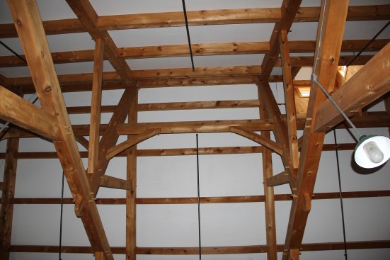 Another view of the roof details in the main hall at the MOFGA Common Ground fairgrounds. Tie beams and knee braces connect the king posts in the main roof trusses, providing added stiffness and stability to the 60-foot roof span.