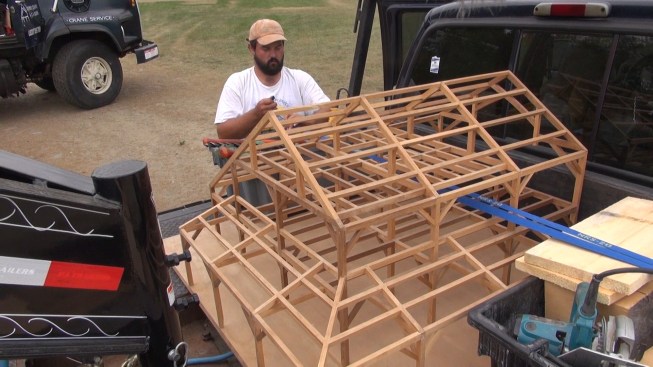 Chris ties the company's scale model display back onto the truck for the trip home.
