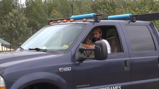 Chris waves goodbye as he pulls out of the fairgrounds with his load of timbers.