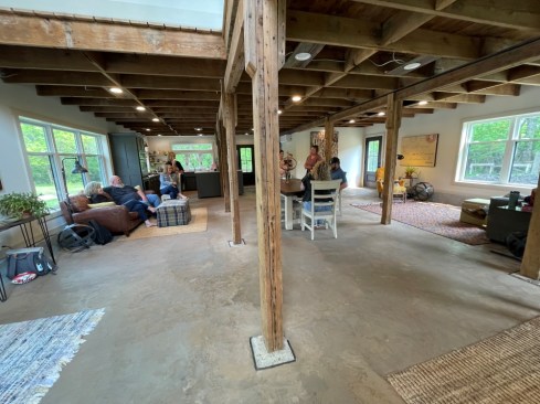 The Porth family gathers in the main living area. Many of the barn’s original wood posts and beams were preserved during the renovation.