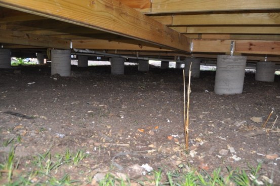 Simple concrete piers make for a very upgrade-able house in the future. Notice no HVAC ducts down here. Simply spray foamed under the subfloor for insulation.