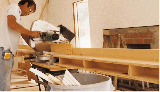 The extension tables run slightly uphill from the saw, making it easier to securely hold bowed trim in place. An 1/8-inch rabbet cut into the bottom front edge of the chop saw fence gives sawdust an outlet, reducing the need to constantly blow dust away.