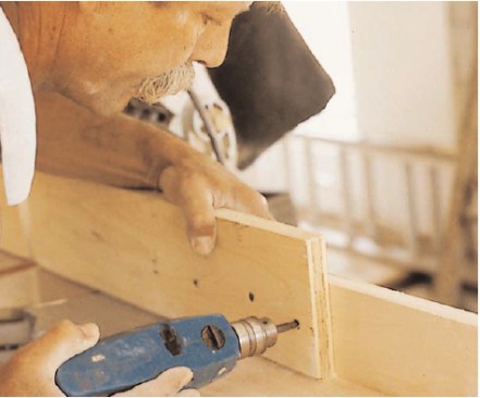 The author’s chop saw setup is designed to make cutting trim as easy and accurate as possible. The extension fences are offset behind the saw fence.