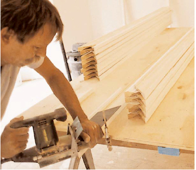 Biscuit joints and miters are cut before any measurements are taken. Here the author uses a plastic jig to support the biscuit joiner when working with narrow trim stock.
