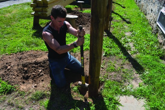 Compacting the soil while backfilling prevents settling around the post and provides it with extra support.