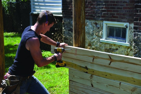 The 2x6 PT planks are fastened to the posts with 3-inch-long structural screws.