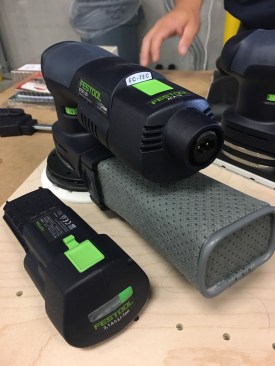 Festool's new hybrid sanders were being demonstrated and garnered a lot of attetion. There are three units in the new sander line: a detail sander, a rectangular shaped, and a 5" random orbital, shown here. The units work with an 18V battery OR a cord via the battery-shaped cord connector pack (shown on the sander here). The batteries are a new platform, though they work with existing slide-style chargers.  