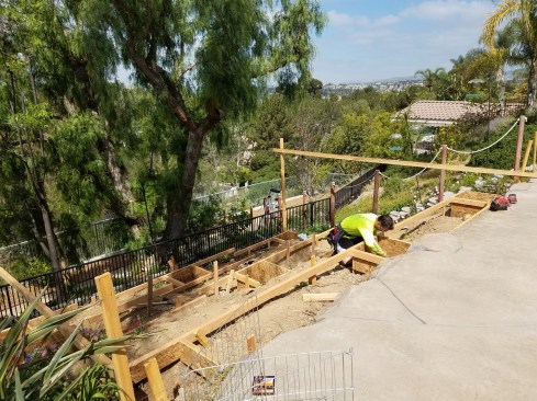 The freestanding deck is located on a steep slope and just one step up from a hardscaped pool surround. Batterboards are essential for an accurate layout.