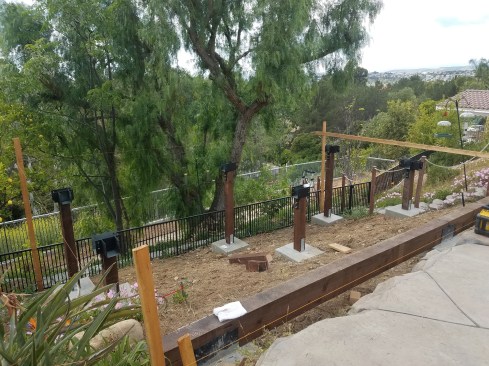 The upper three footings support a continuous 6x12 PT beam; the other footings support 6x6 posts.