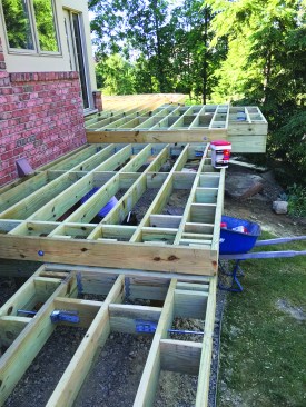 Vertical blocking reinforced with lateral-load brackets will provide support for picture-framed border decking while strengthening the rim joist.