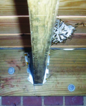 All of the holes in metal hardware should be filled with approved hanger nails or structural screws, and the hanger flanges should fit snugly against the joist.