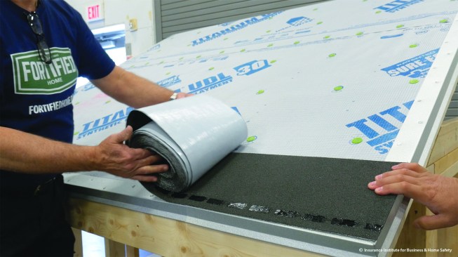 A good weather seal between shingles and underlayment is key to preventing damage in a storm. One approach is to apply a self-adhered manufactured starter strip.