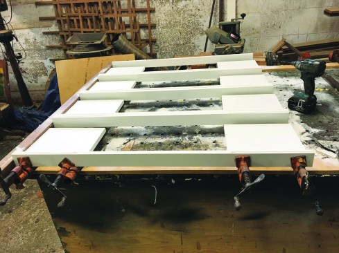 Switching to a slow-cure adhesive allowed him to glue up several frames at once, but the frames needed to remain clamped for an hour.